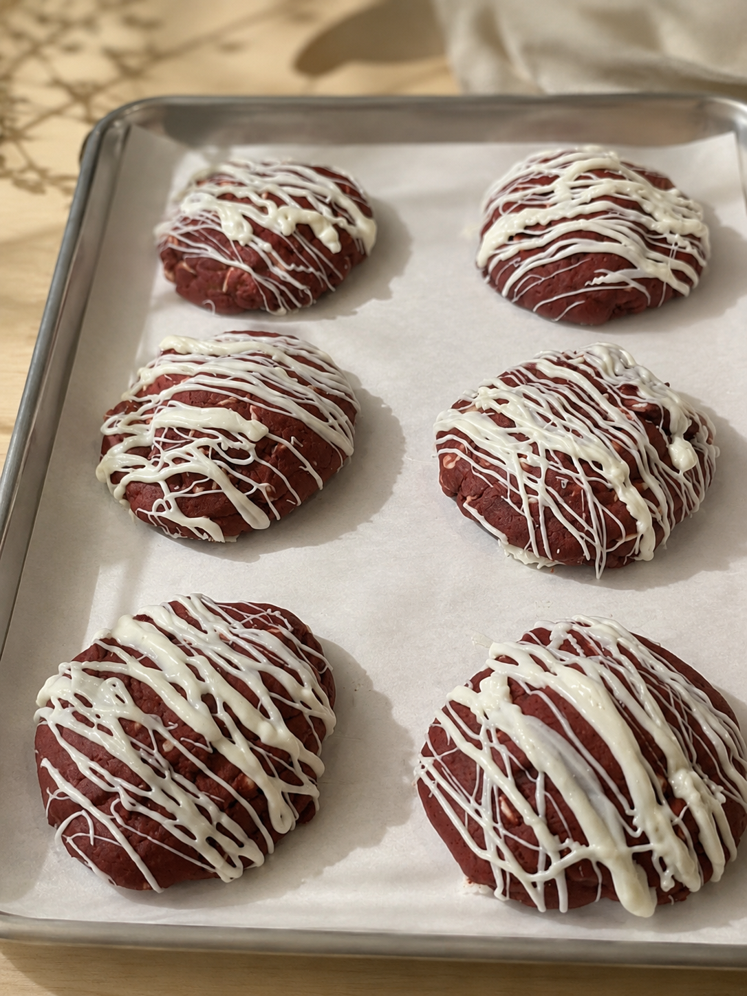 Red velvet cookies with white chocolate drizzle